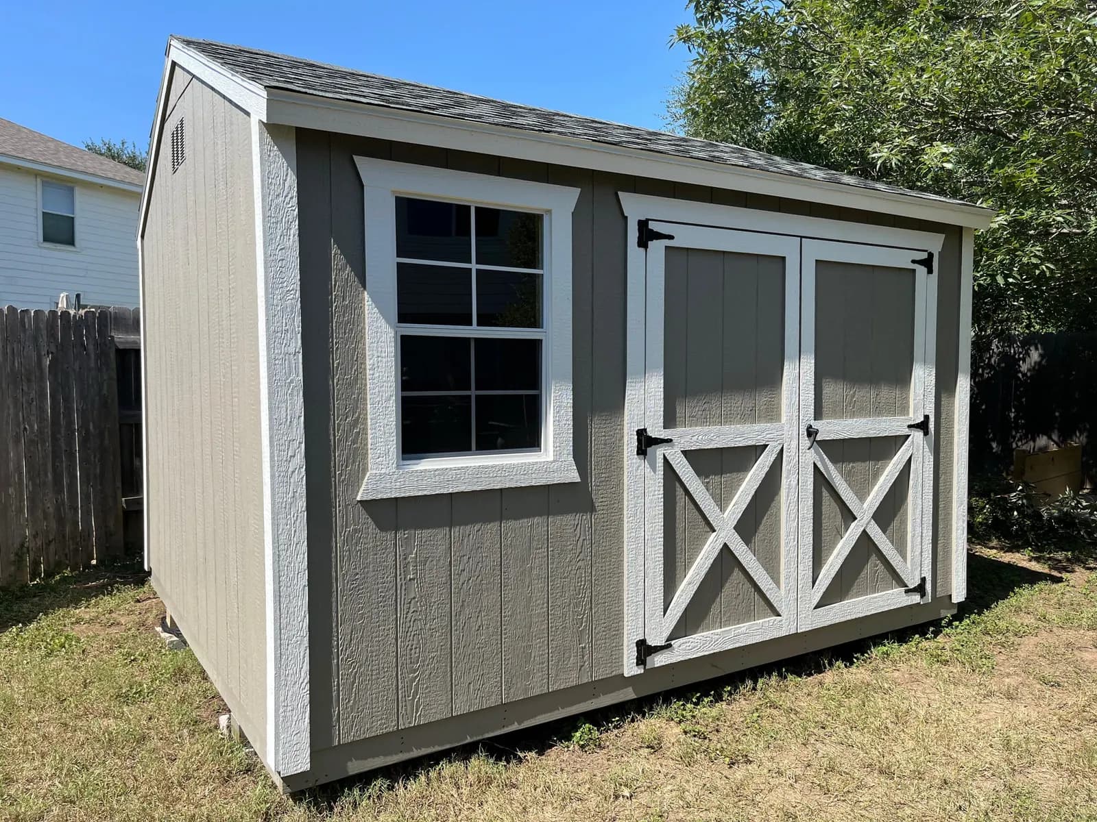 Real backyard storage shed used to organize outdoor equipment